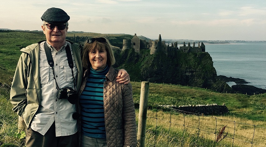 Joan and Jack in front of a castle in Northern Ireland