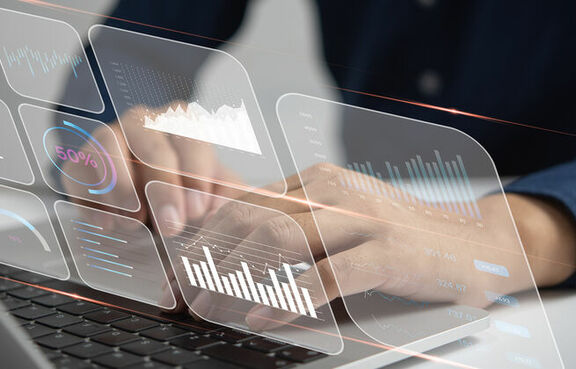 Man at a laptop looking at an analytical dashboard