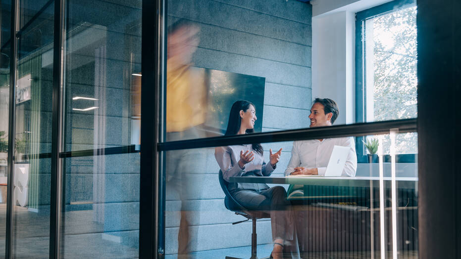 Business professionals meeting in a glass office