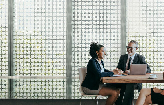 Three businesspeople meeting in a conference room
