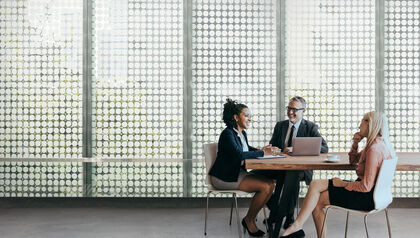 Three businesspeople meeting in a conference room