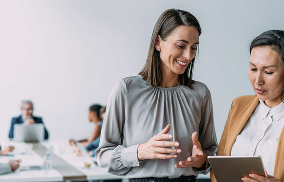 Two women speaking in an office setting