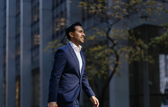 Man in suit walking with a briefcase