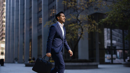 Man in suit walking with a briefcase