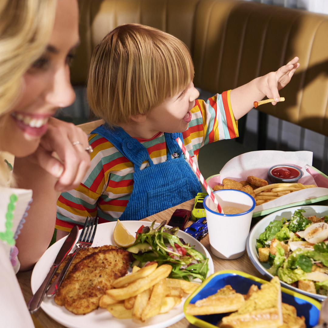 Family enjoying dishes dining in The Piazza