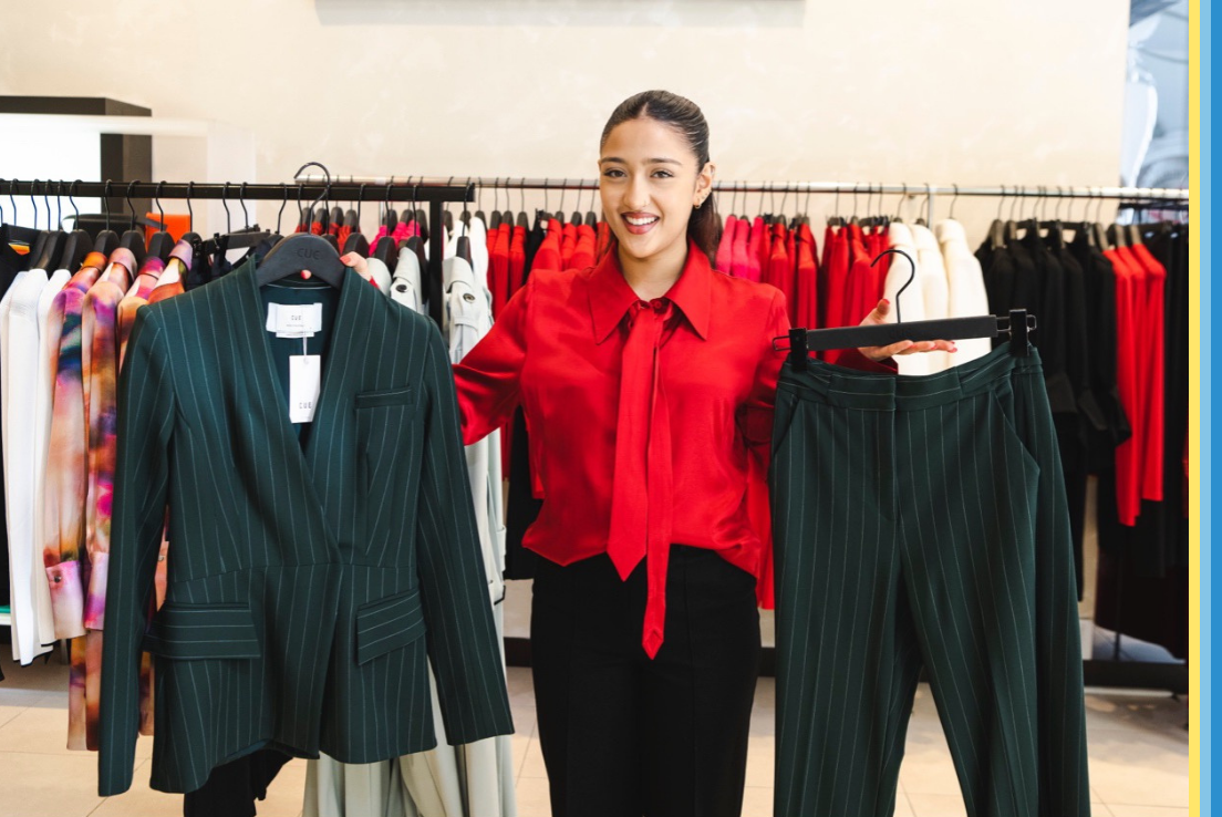 Image of a women holding up two options for clothes for a job interview