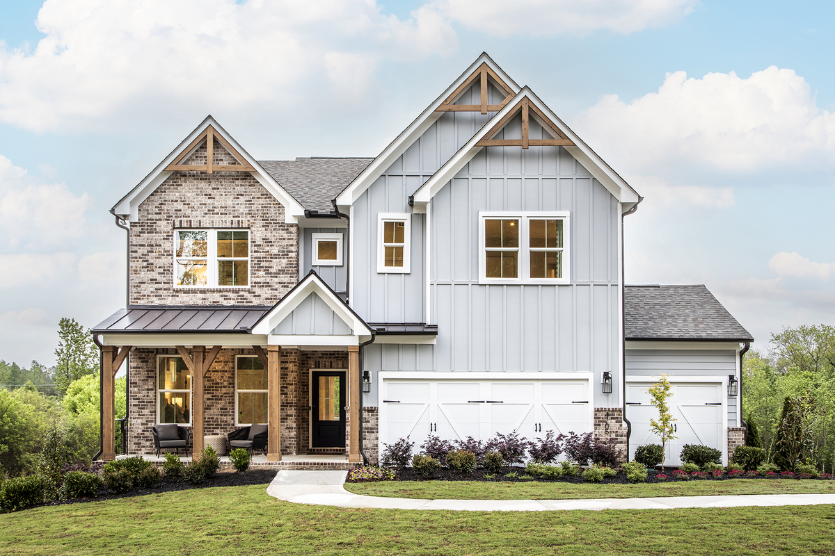 front of 2-story home with light siding and brick