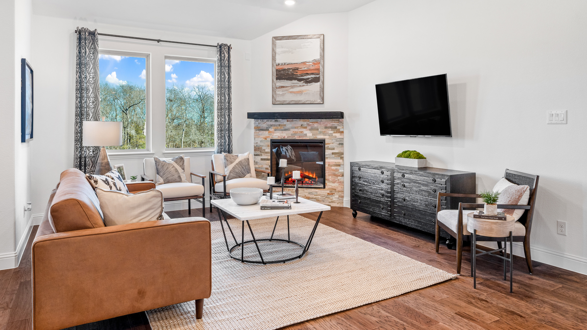 open great room with wood floors and fireplace
