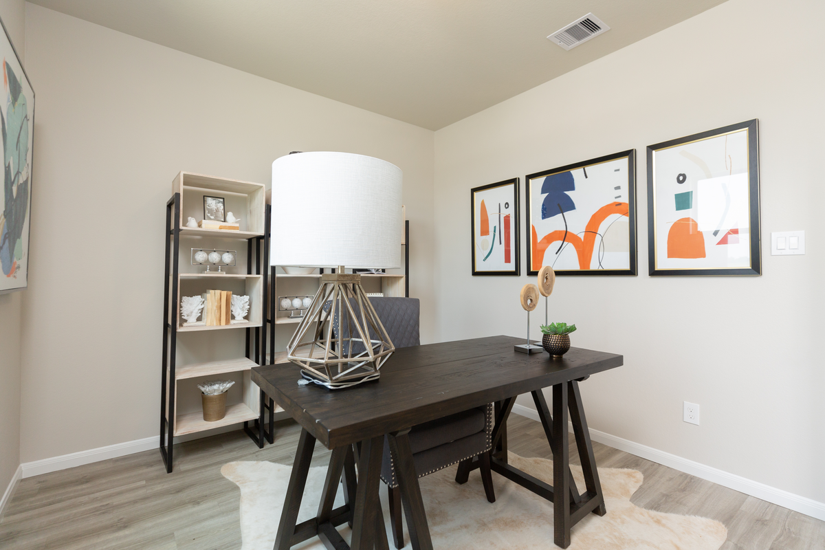 study with dark wooden desk and large table lamp