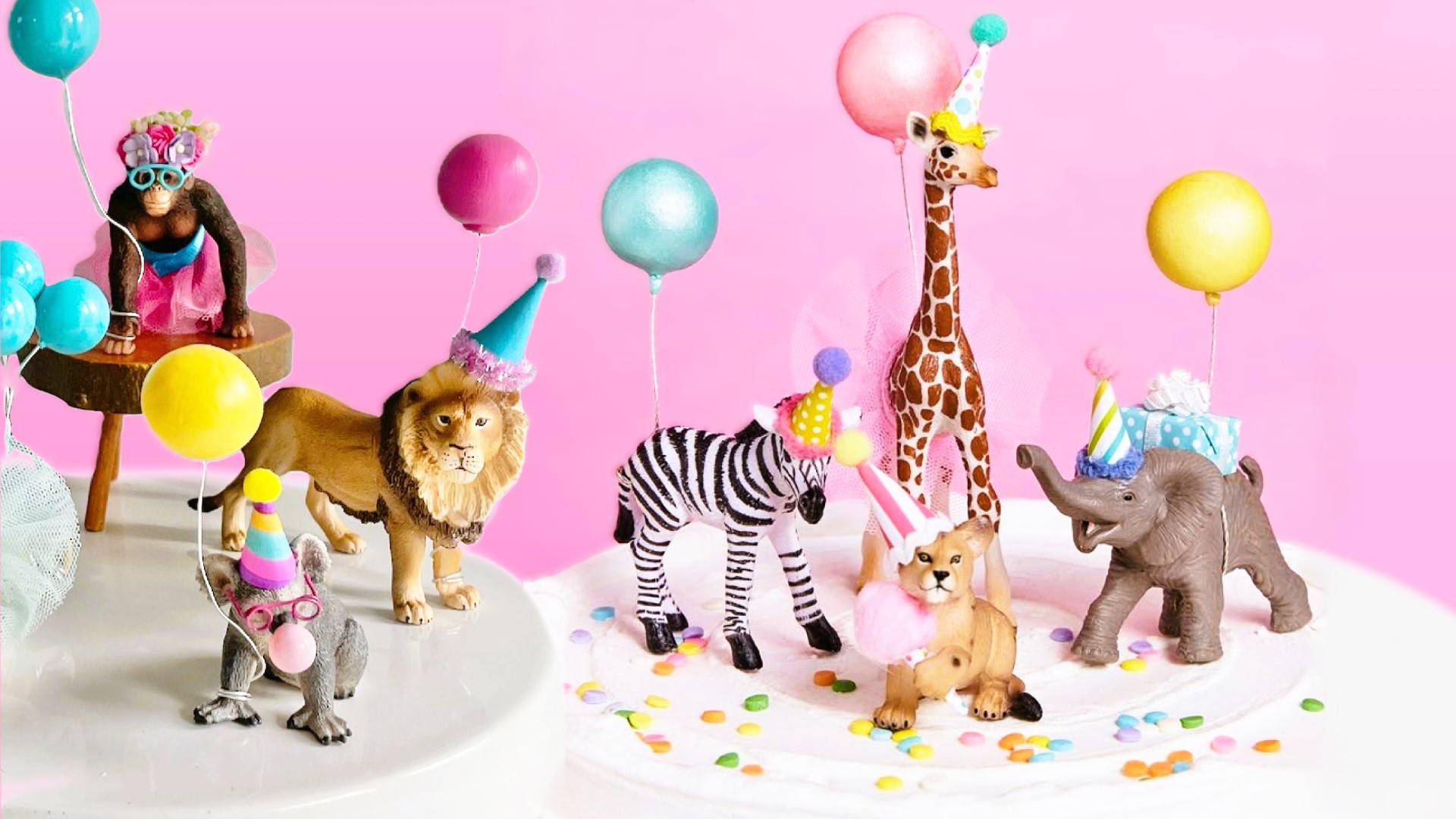 Safari toys dressed in balloons and party hats