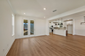 great room with wood floors, white walls and large windows