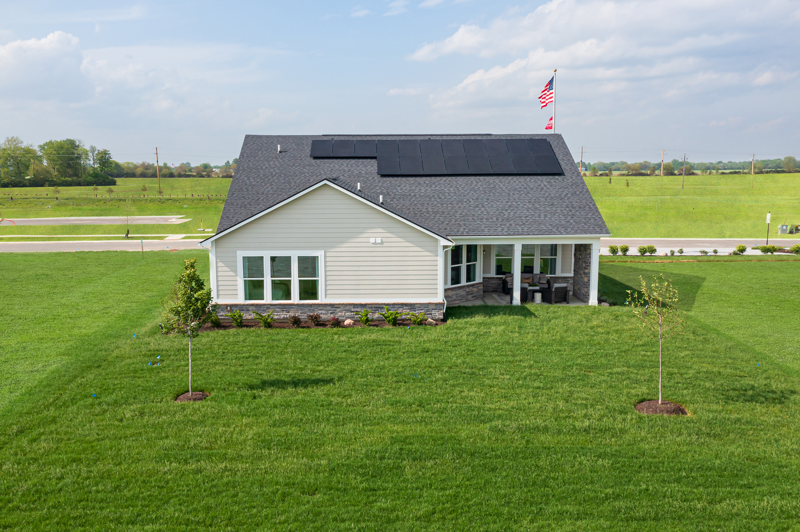 back exterior of home with solar panels on roof