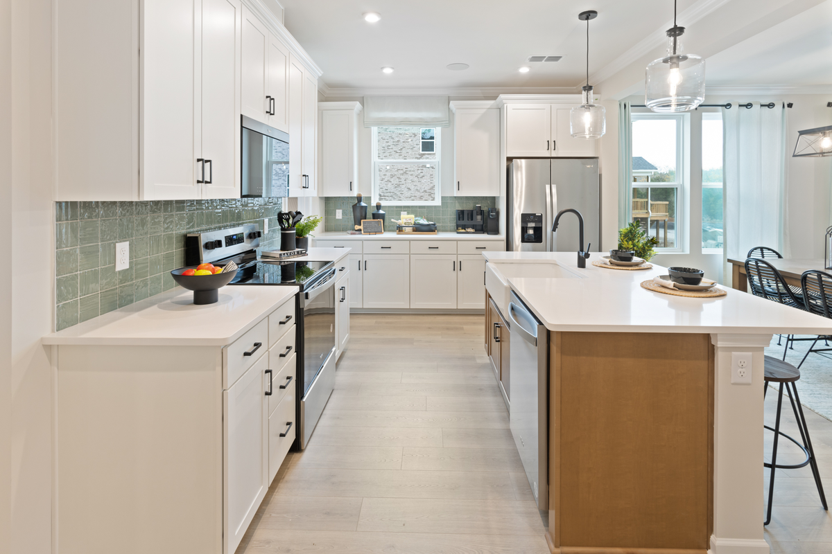 kitchen with white cabinets and a green backsplash