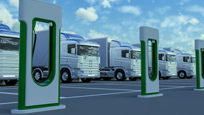 Electric trucks in a parking lot with charging stations