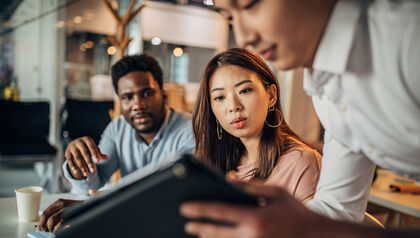 Colleagues collaborating with tablet
