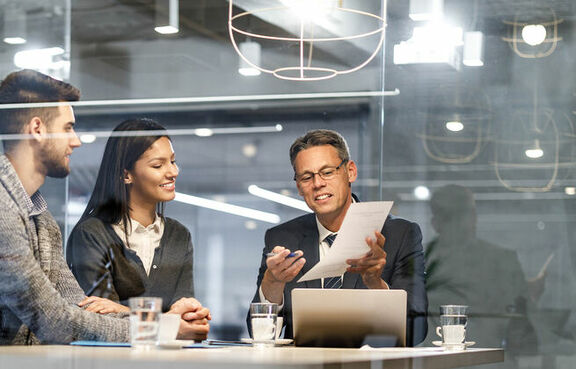Couple looking at paperwork with their insurance agent