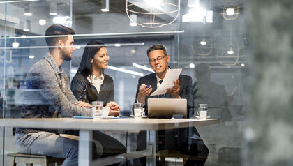 Couple looking at paperwork with their insurance agent