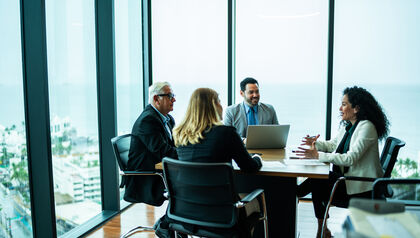 Professionals sitting at a conference table in a meeting