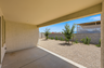spacious covered patio with recessed lighting and views of the landscaped backyard with trees