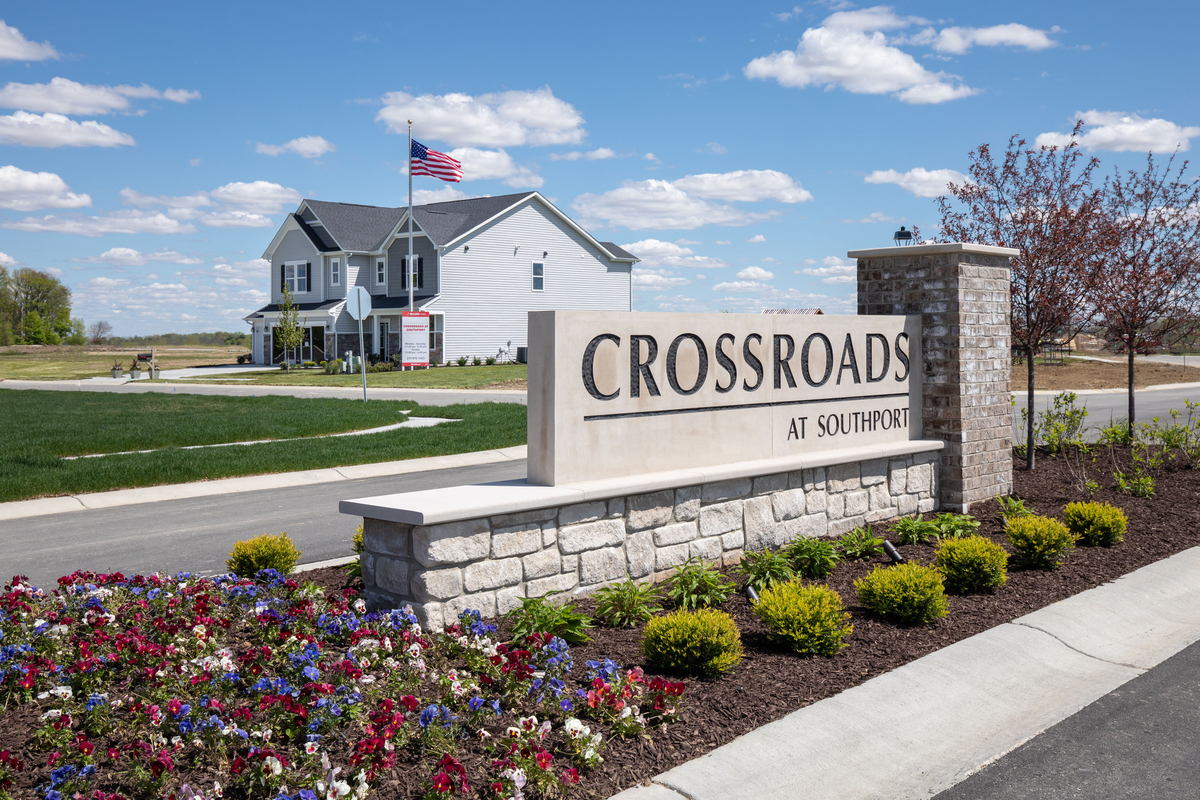 stone entrance sign with planted flowers