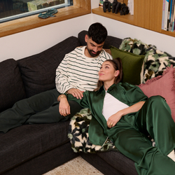 Couple lounging together in green toned comfy wear