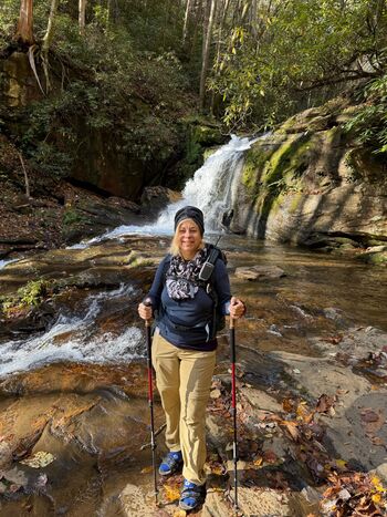 Photo of Danielle Sweet standing in front of a waterfall