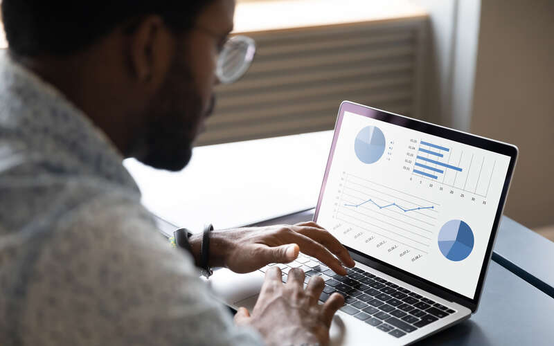 Man studying data on laptop