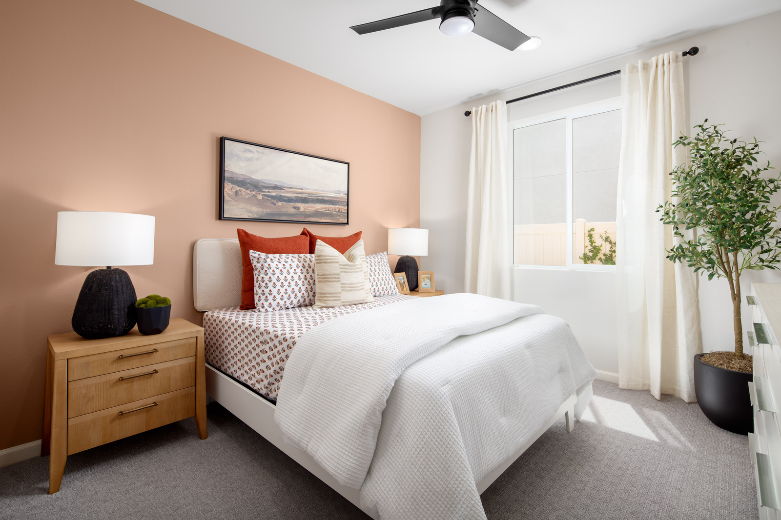 bedroom with large window and neutral carpet