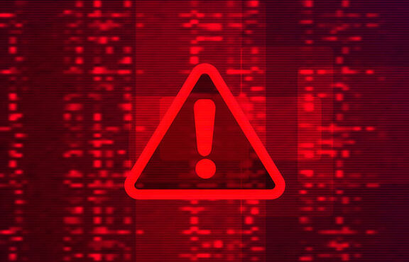 Digital red warning sign in front of binary code