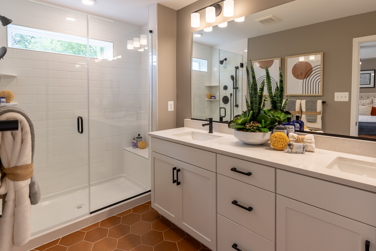 primary bath with copper colored designer flooring
