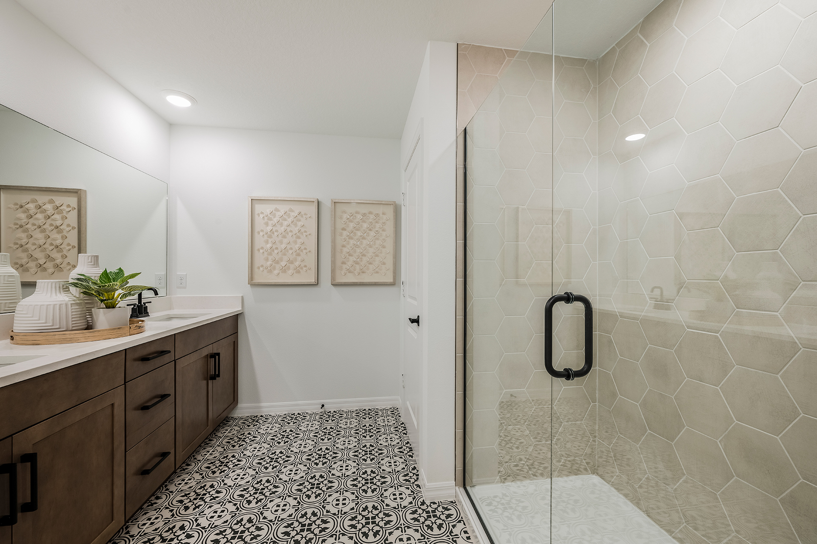 primary bathroom with enlarged glass shower and patterned tile