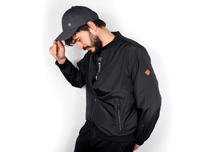 Neumann.Berlin Merchandise: Grey Cap and Flight Jacket on Model