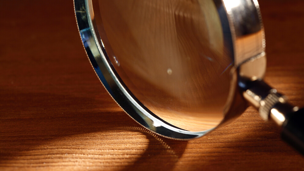 Magnifying glass on wooden table