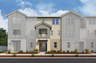 exterior of three-story townhome with desert landscaping and large windows