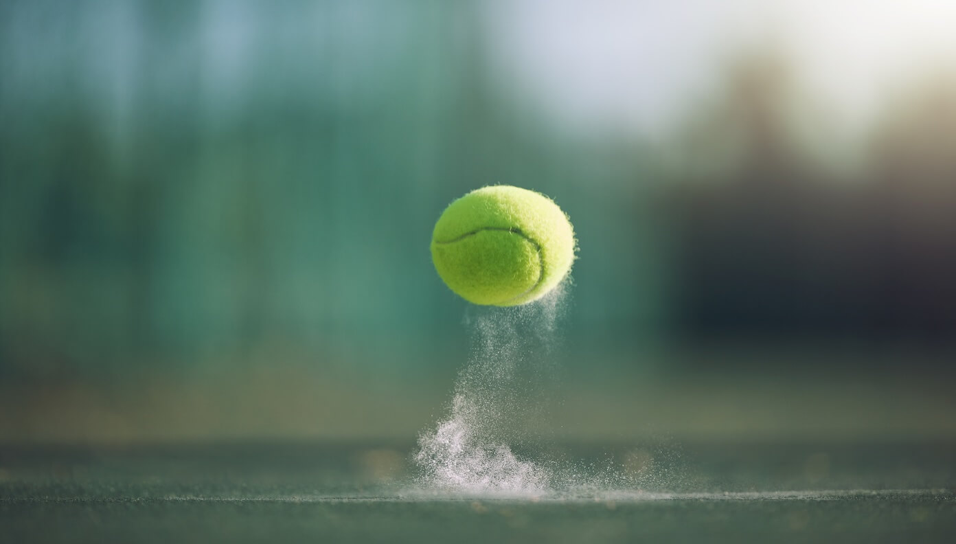 Image of a tennis ball in mid-air. 