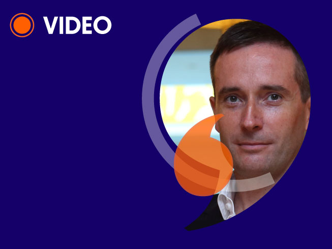 Headshot of Graham Norris, cropped in quotation mark frame, with text 'video'