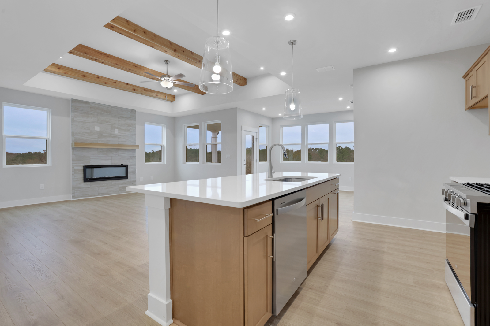 view of great room kitchen with natural light and wood accents