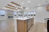 view of great room kitchen with natural light and wood accents