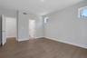 primary bathroom with white cabinets and tile flooring 