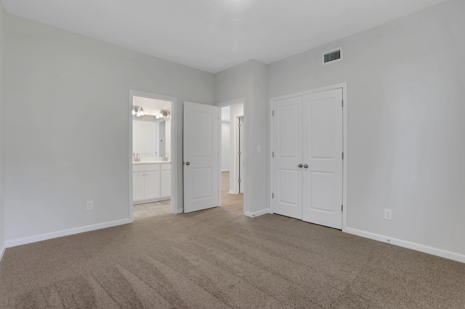 bedroom with windows and carpet