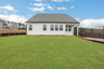 back of home with covered patio and sizable backyard
