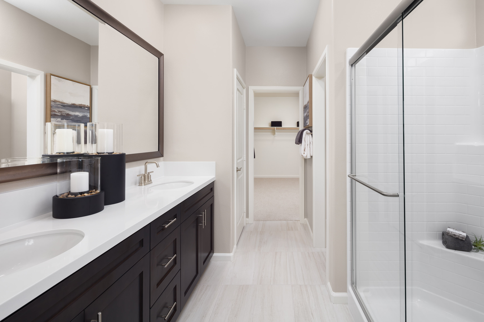 primary bathroom with white countertops and neutral tile floors