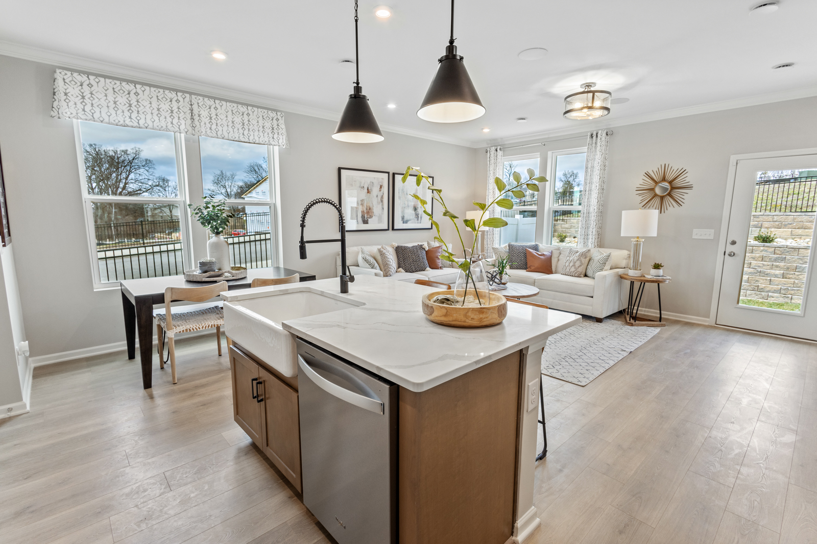 kitchen with sink in island, stainless steel appliances, and wood floors