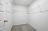 primary closet with built in shelf