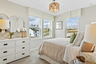 bedroom with large windows and carpet