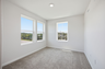 secondary bedroom with carpet, large windows, and double door closet