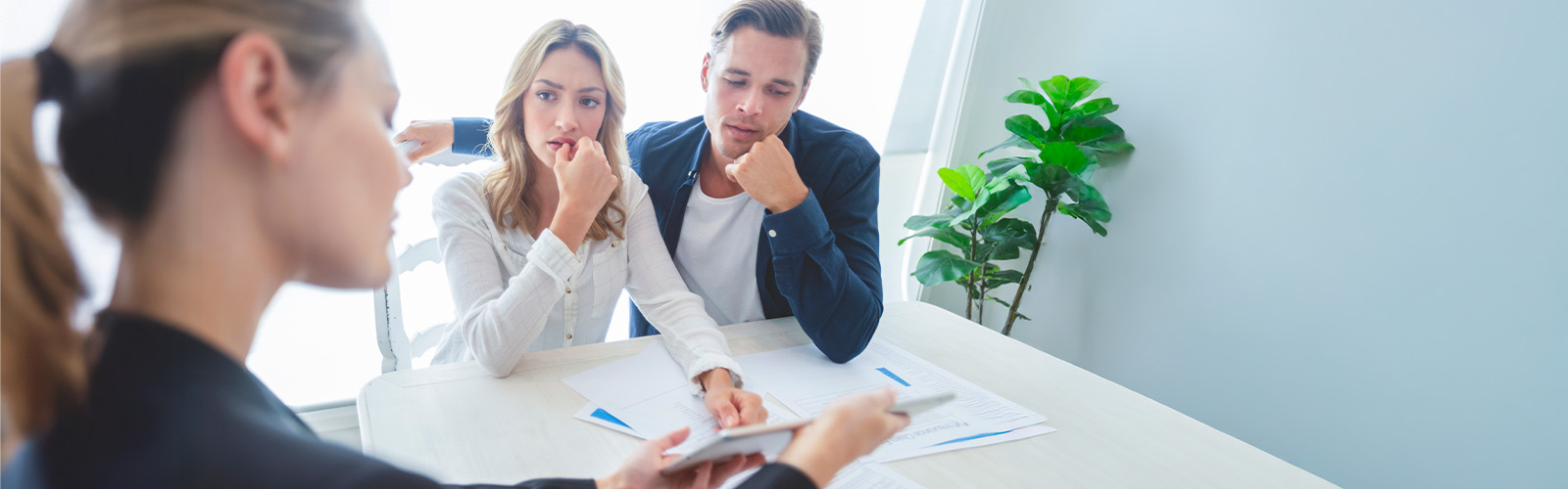 Young homebuyers discussing their options with a loan officer