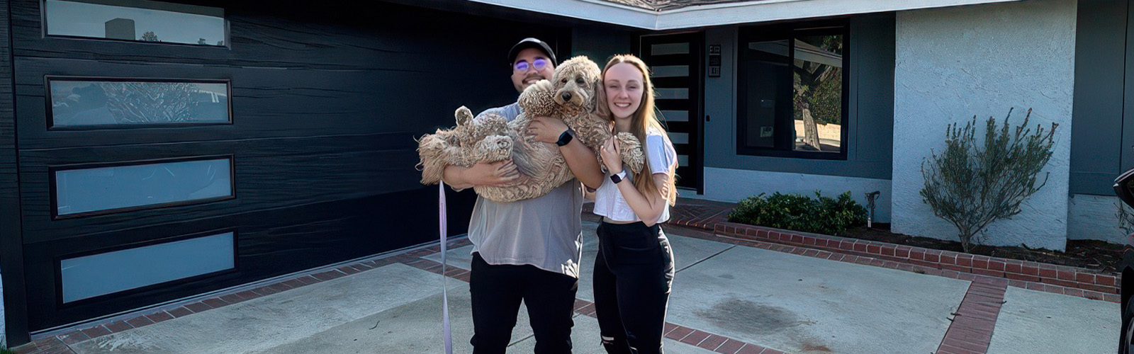 NAF's Kasey and Zo Cruz standing in front of their home