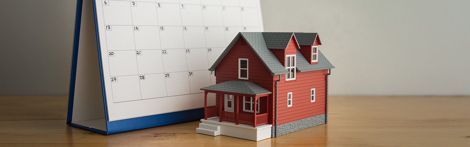 Toy house next to a calendar