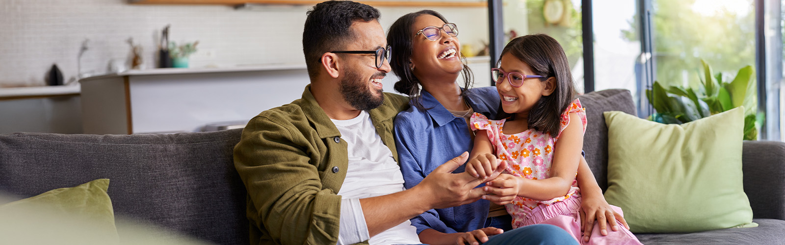 A happy family sitting together on the couch